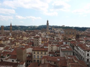 The tower of the Palazzo Vecchio pops up above the red rooves of Florence